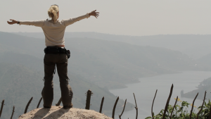 billie arms out wide over lake